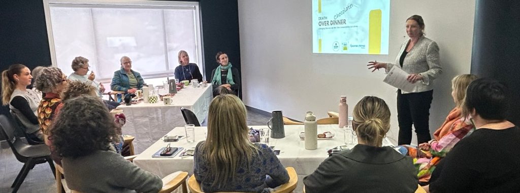 A woman presenting in front of seated participants